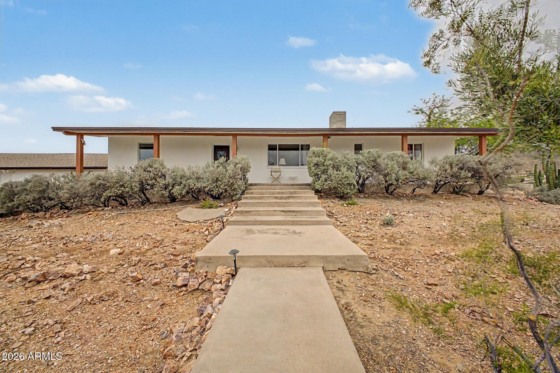 1702 East Griswold Road Phoenix, AZ 85020 - Photo 2 of 38 a front view of a house with a yard and garage