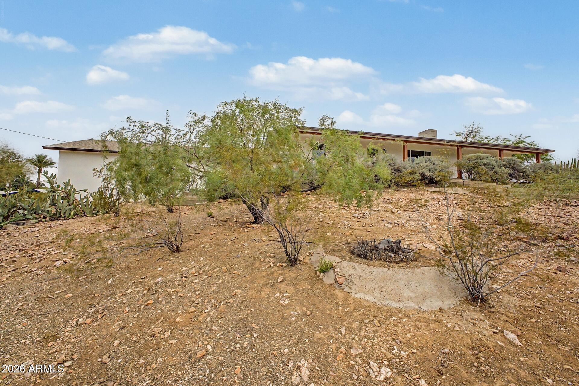 1702 East Griswold Road Phoenix, AZ 85020 - Photo 3 of 38 a view of a dry yard with wooden fence