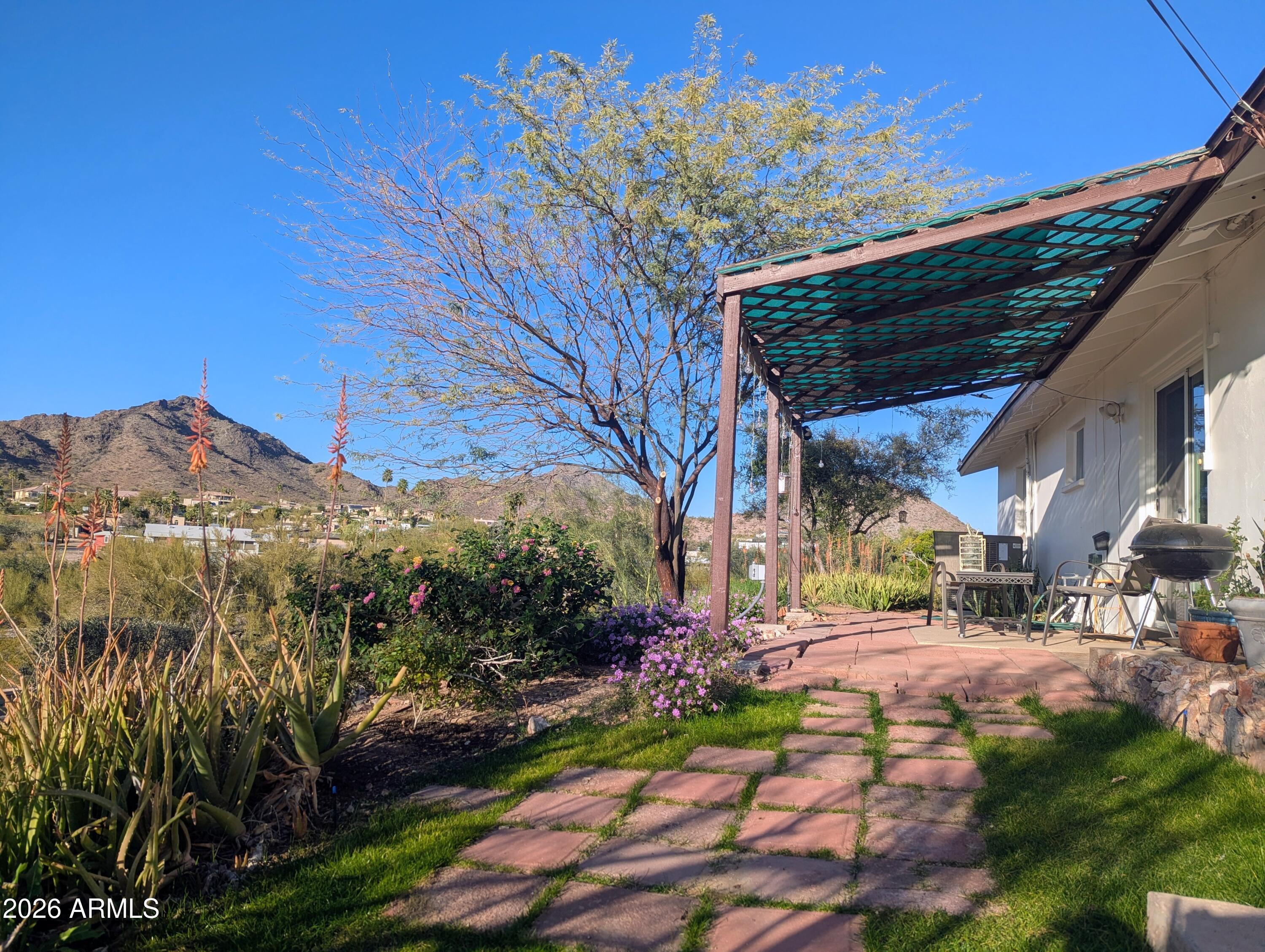 1702 East Griswold Road Phoenix, AZ 85020 - Photo 31 of 38 a view of a backyard with plants and a patio