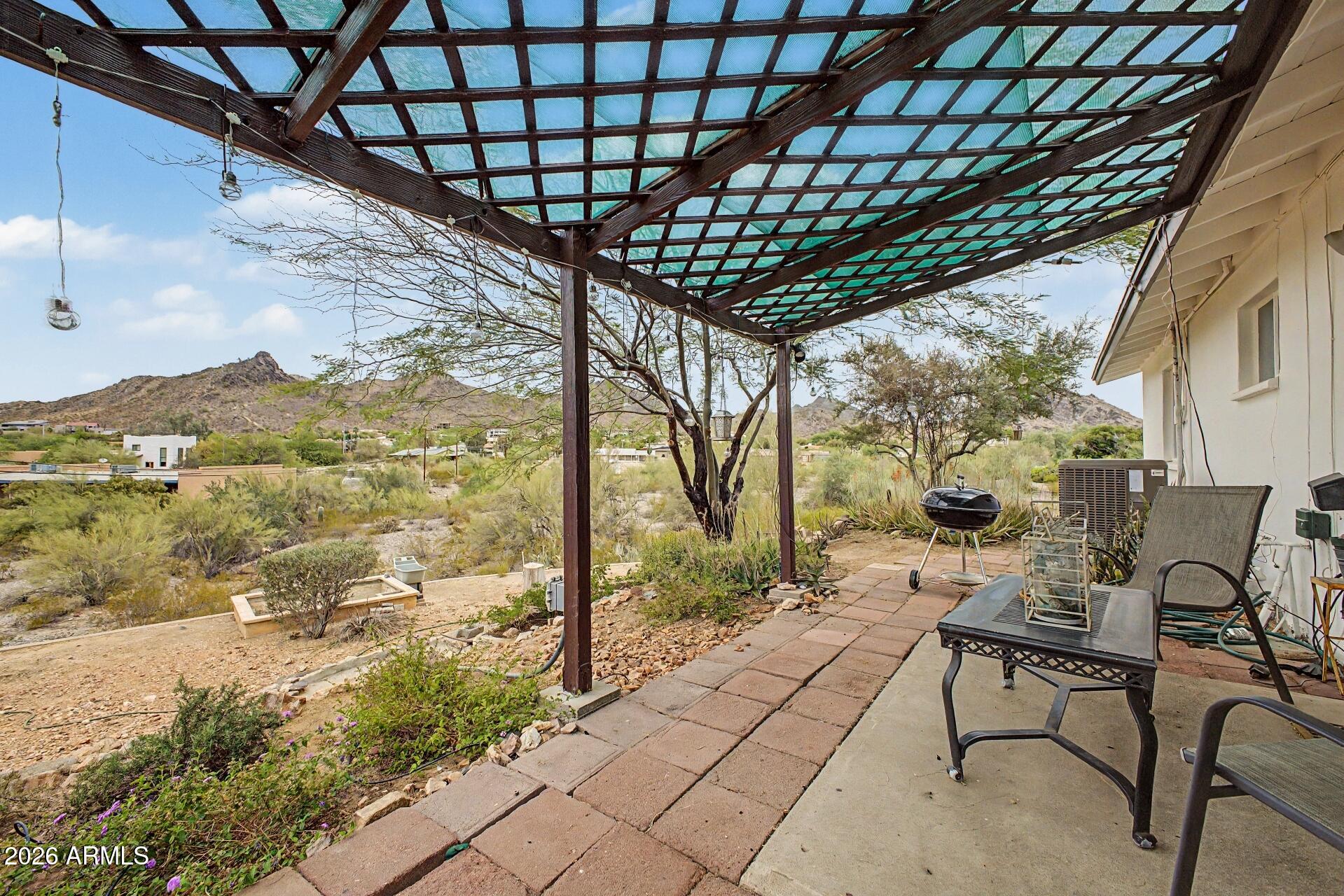 1702 East Griswold Road Phoenix, AZ 85020 - Photo 32 of 38 a patio with glass top table and chairs