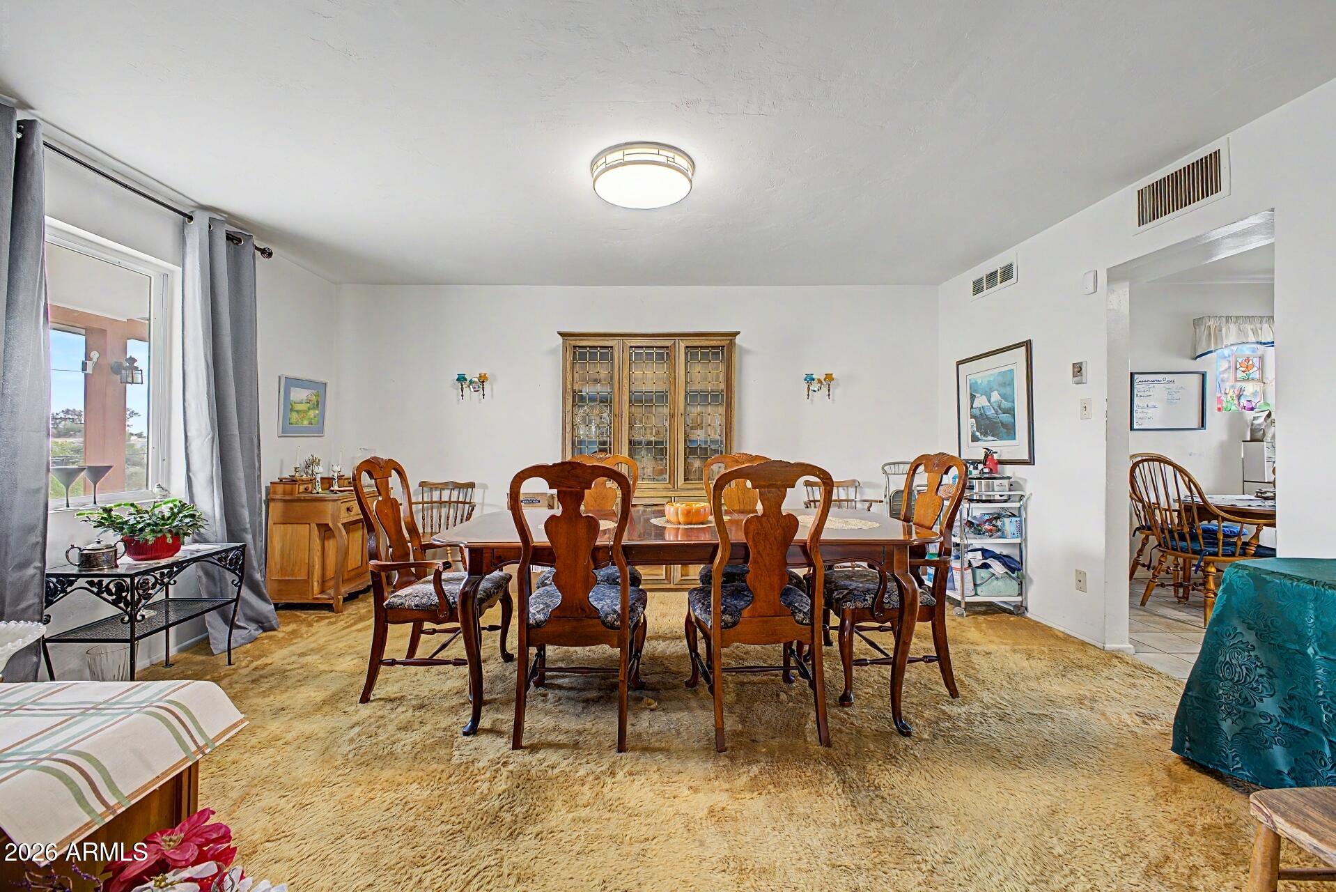 1702 East Griswold Road Phoenix, AZ 85020 - Photo 9 of 38 a view of a dining room and hall with furniture