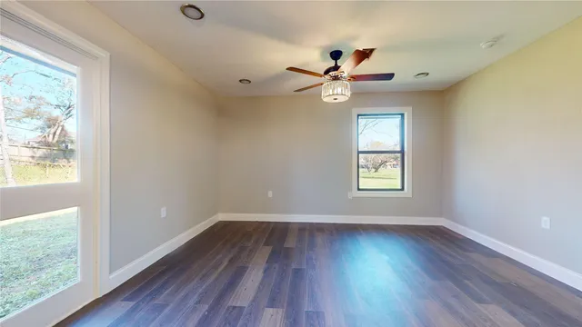 wooden floor in an empty room with a window