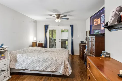 a bedroom with a bed and a flat screen tv