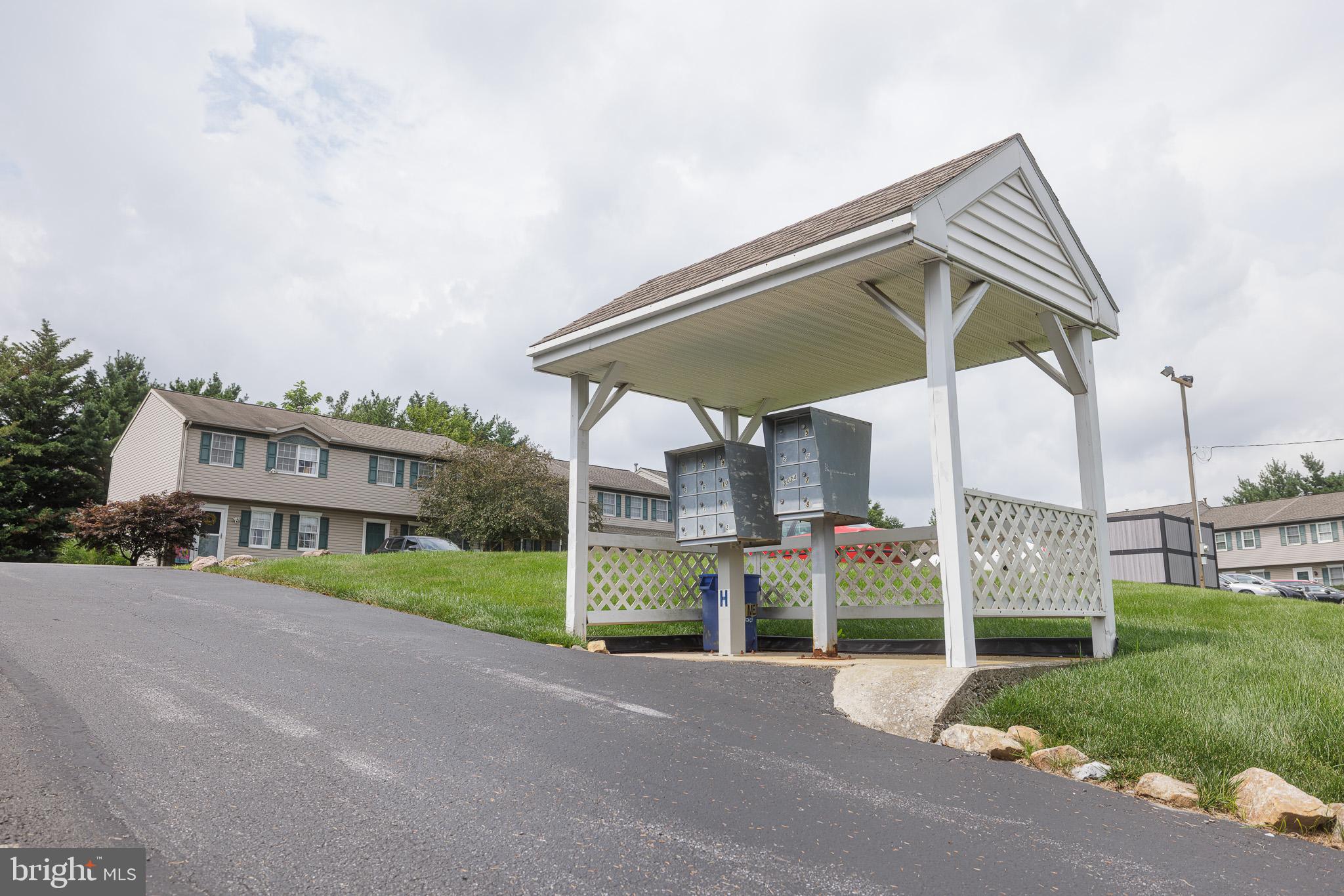 3022 Oak Drive Sinking Spring, PA 19608 - Photo 27 of 28 a front view of a house with a yard and table and chairs under an umbrella