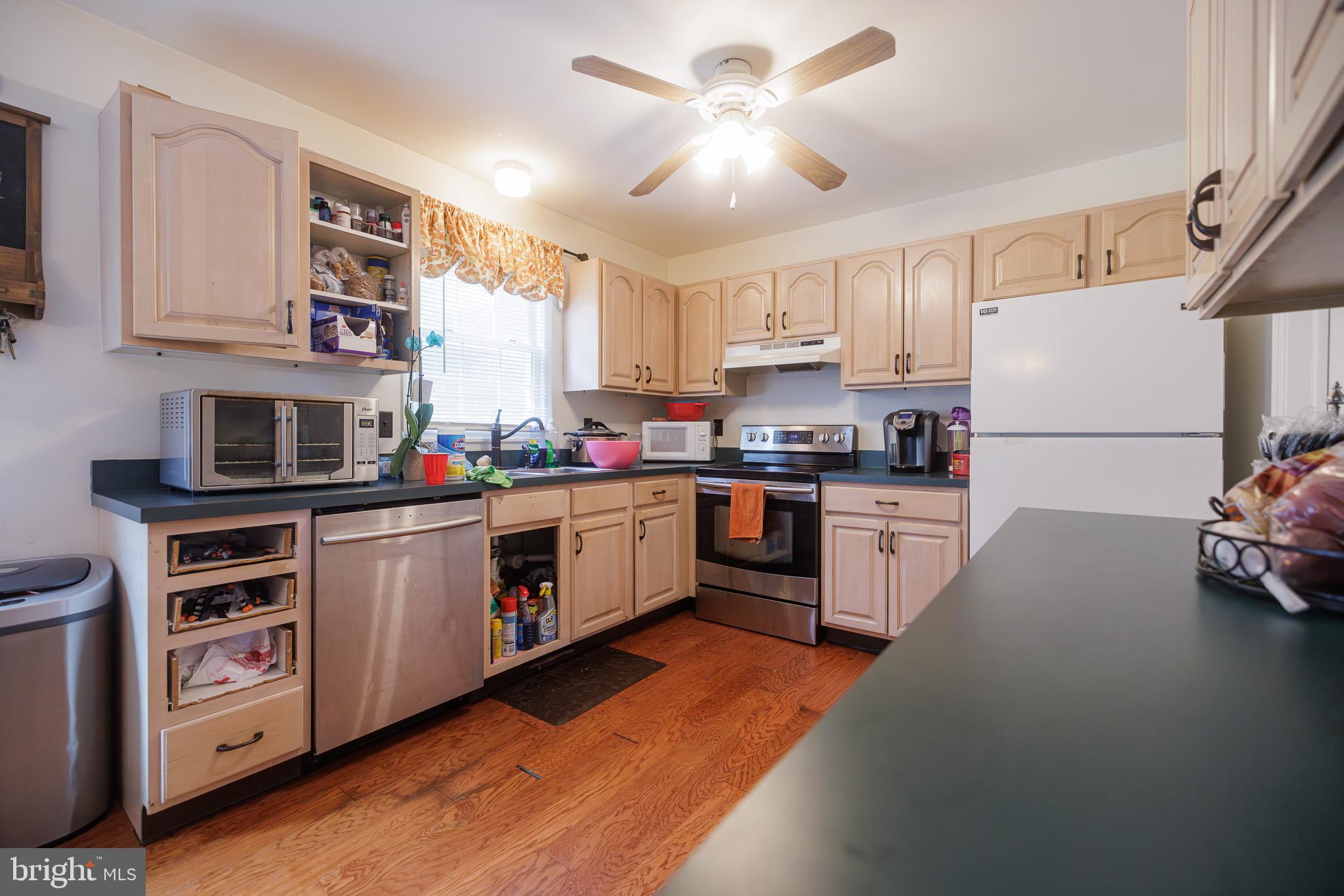 3022 Oak Drive Sinking Spring, PA 19608 - Photo 9 of 28 a kitchen with stainless steel appliances a sink a stove a refrigerator cabinets and a window