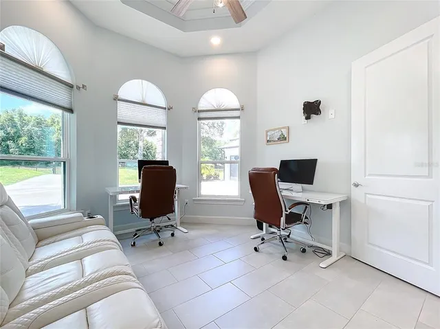 an aerial view of a house with a yard basket ball court and outdoor seating