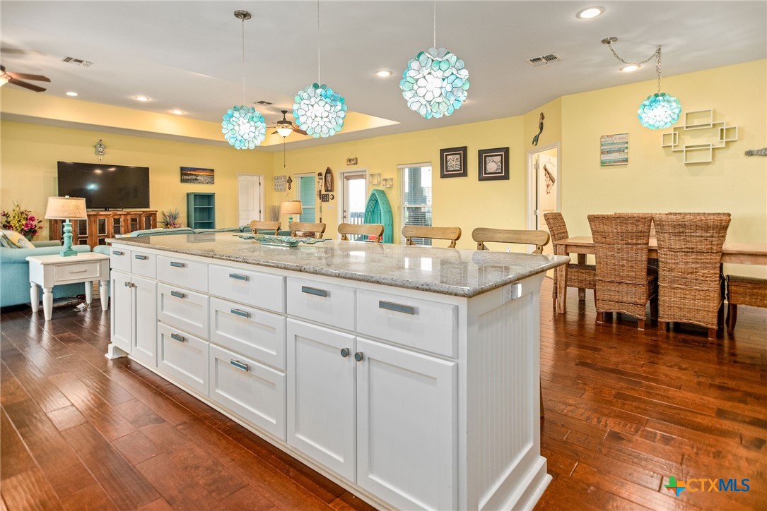 23 Macey Street Port O'Connor, TX 77982 - Photo 24 of 47 a kitchen with center island table and chairs