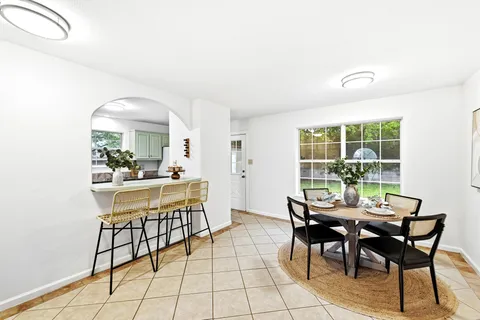 a view of a dining room with furniture window and outside view
