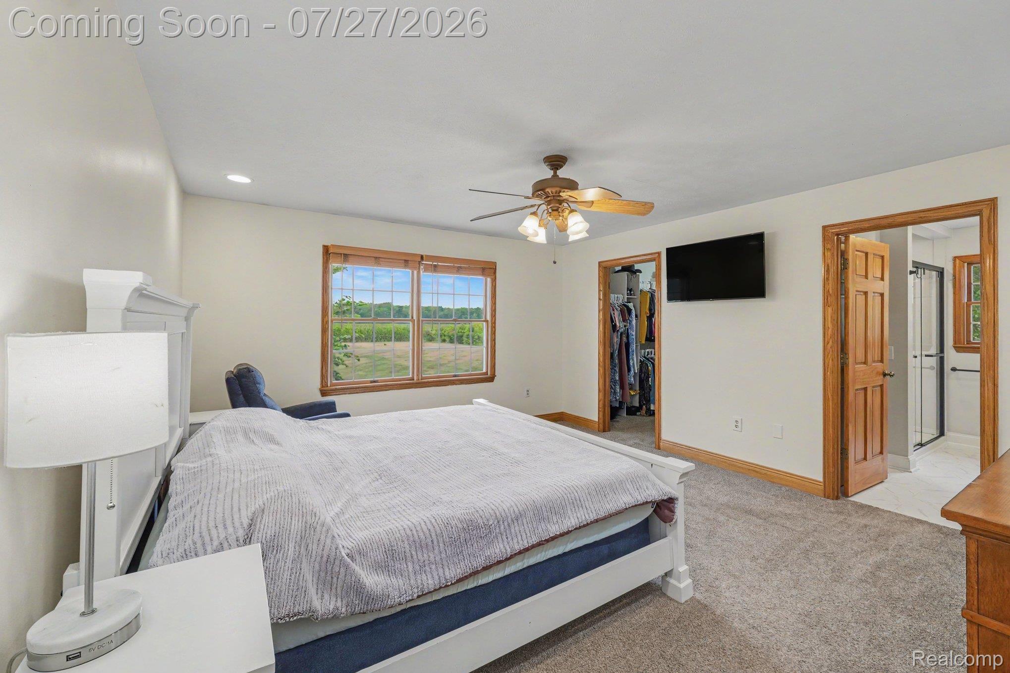 3064 South Reed Road Durand, MI 48429 - Photo 10 of 22 Carpeted bedroom with a ceiling fan, recessed lighting, and a double window