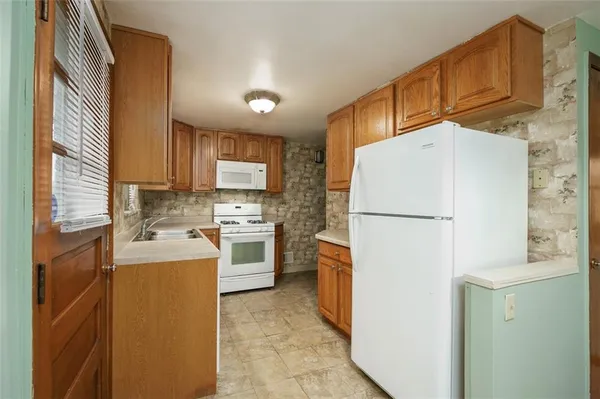 a bathroom with a sink and a refrigerator
