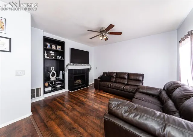 a living room with furniture a fireplace and a flat screen tv
