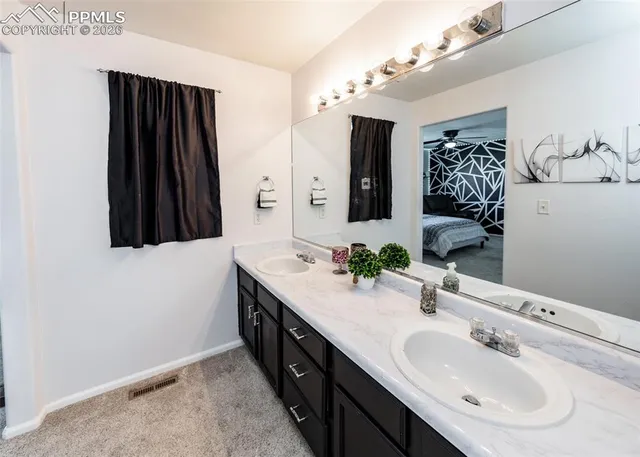 a bathroom with a double vanity sink and a mirror