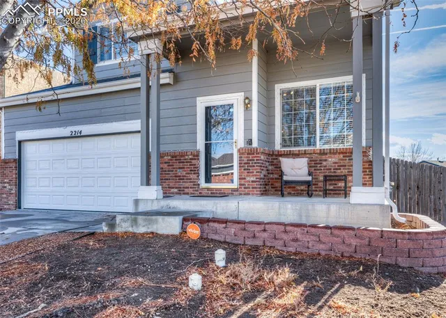 a front view of a house with large windows