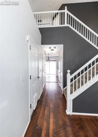a view of an entryway with wooden floor