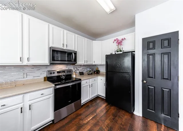 a kitchen with a refrigerator stove and sink