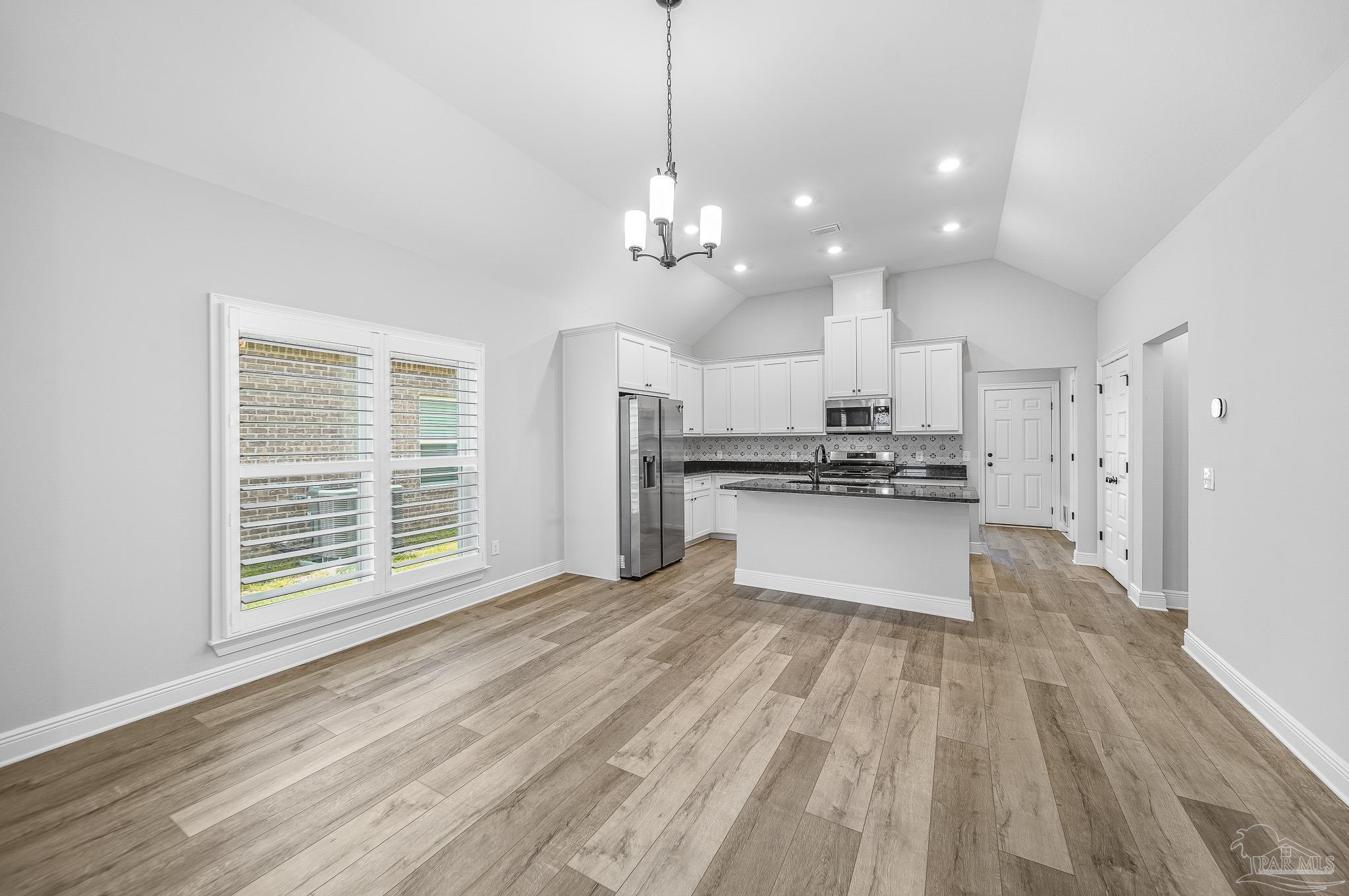 8977 Eureka Street Milton, FL 32583 - Photo 11 of 44 a view of kitchen with granite countertop cabinets and refrigerator