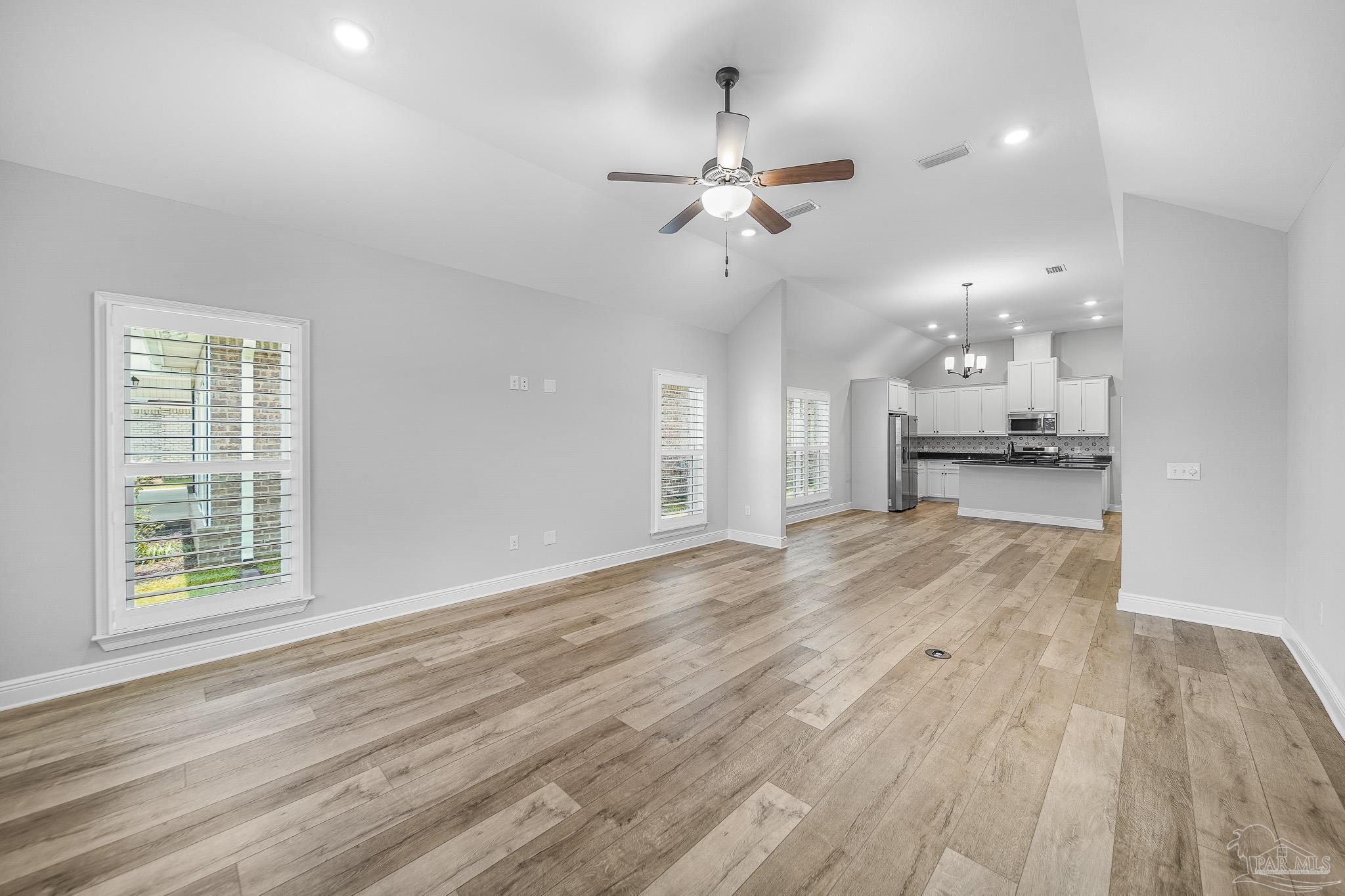 8977 Eureka Street Milton, FL 32583 - Photo 15 of 44 a view of an empty room and kitchen view