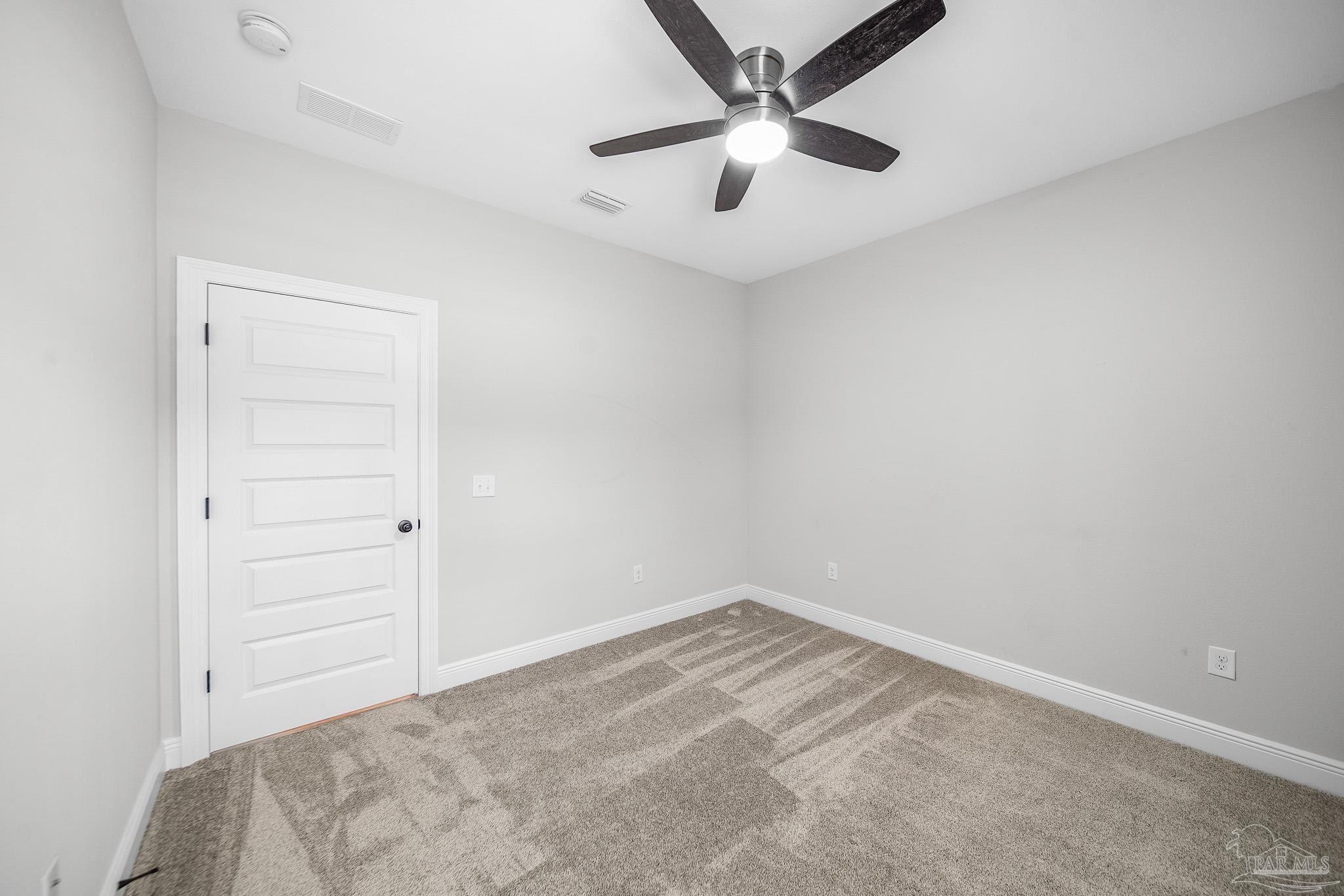 8977 Eureka Street Milton, FL 32583 - Photo 20 of 44 an empty room with a window and a ceiling fan