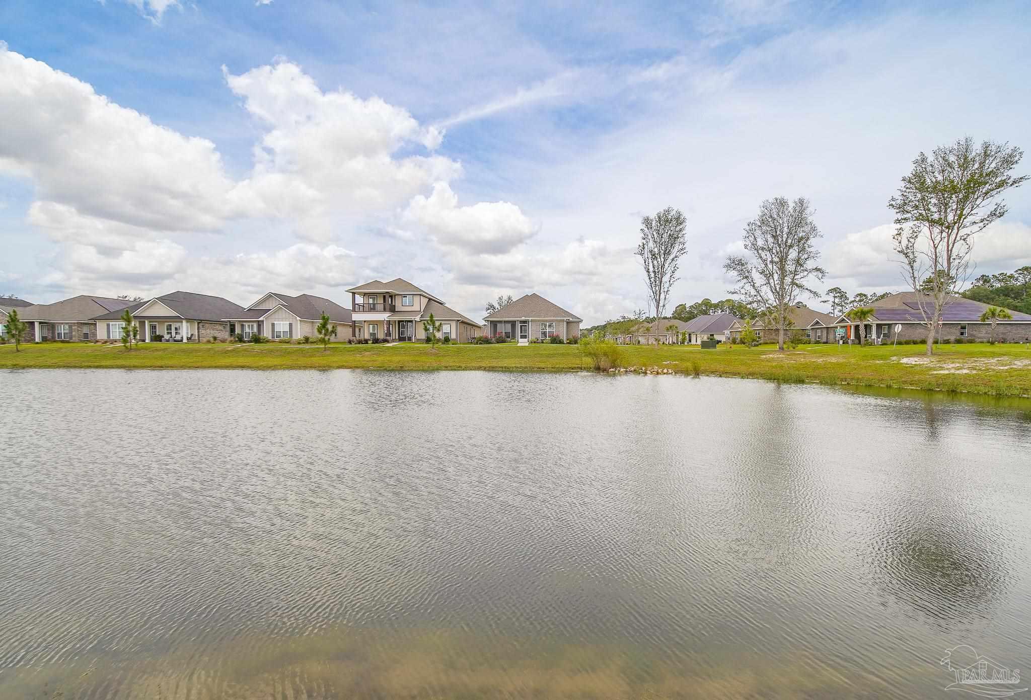 8977 Eureka Street Milton, FL 32583 - Photo 2 of 44 a view of a lake with houses in the back