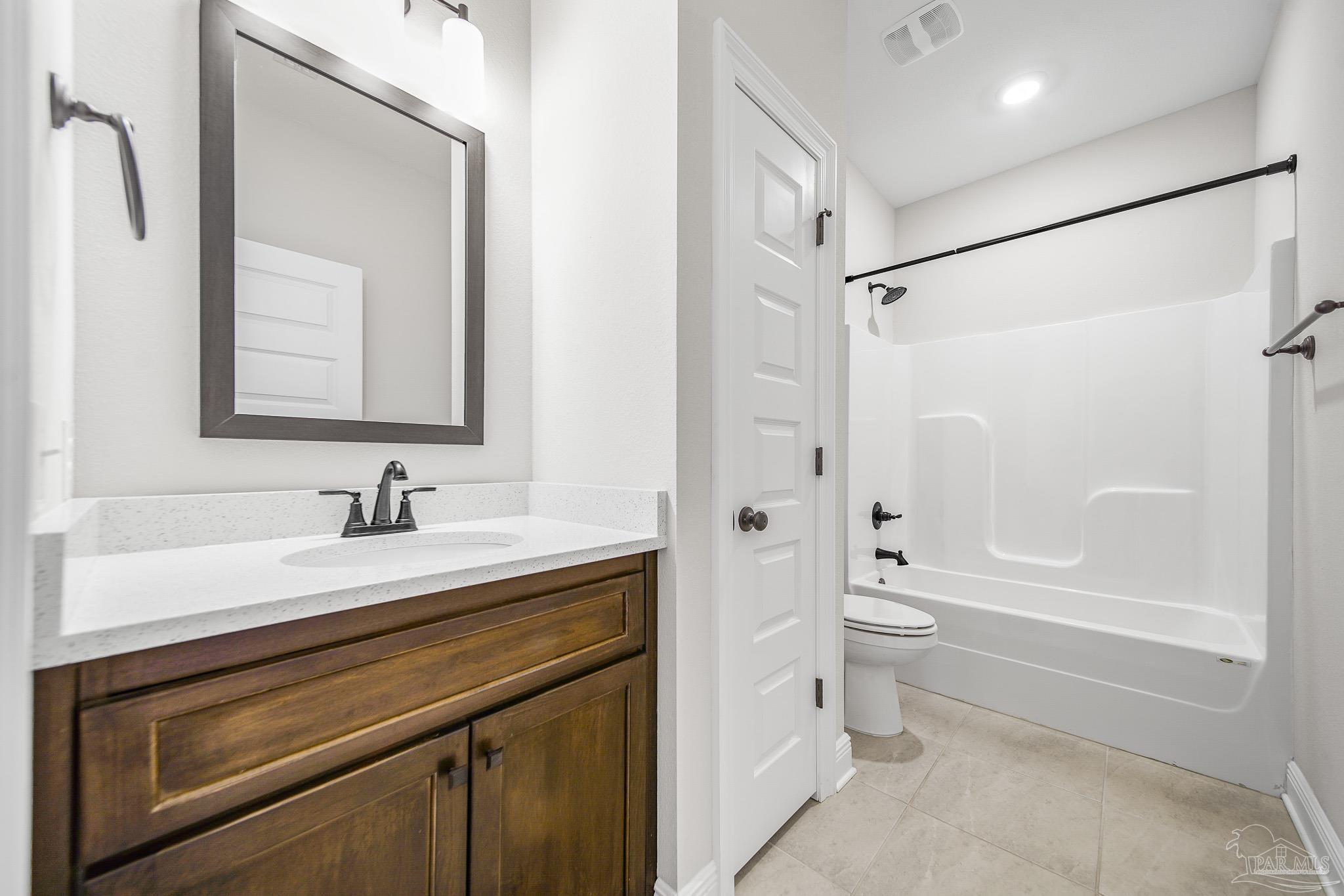 8977 Eureka Street Milton, FL 32583 - Photo 22 of 44 a bathroom with a sink a toilet and a bathtub