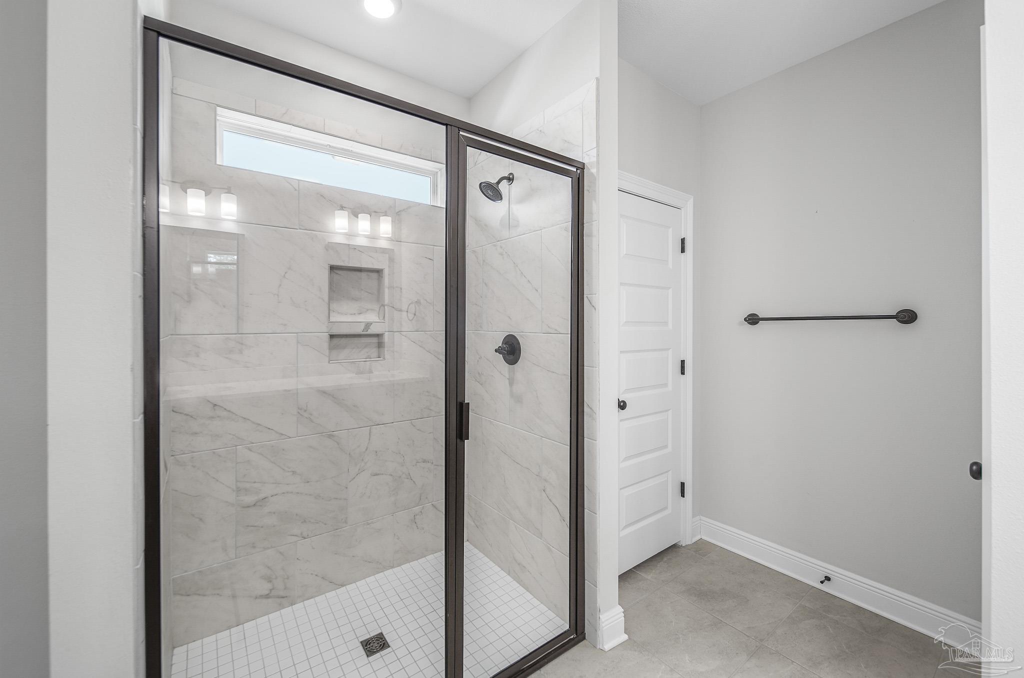 8977 Eureka Street Milton, FL 32583 - Photo 27 of 44 a bathroom with a glass shower door and a shower