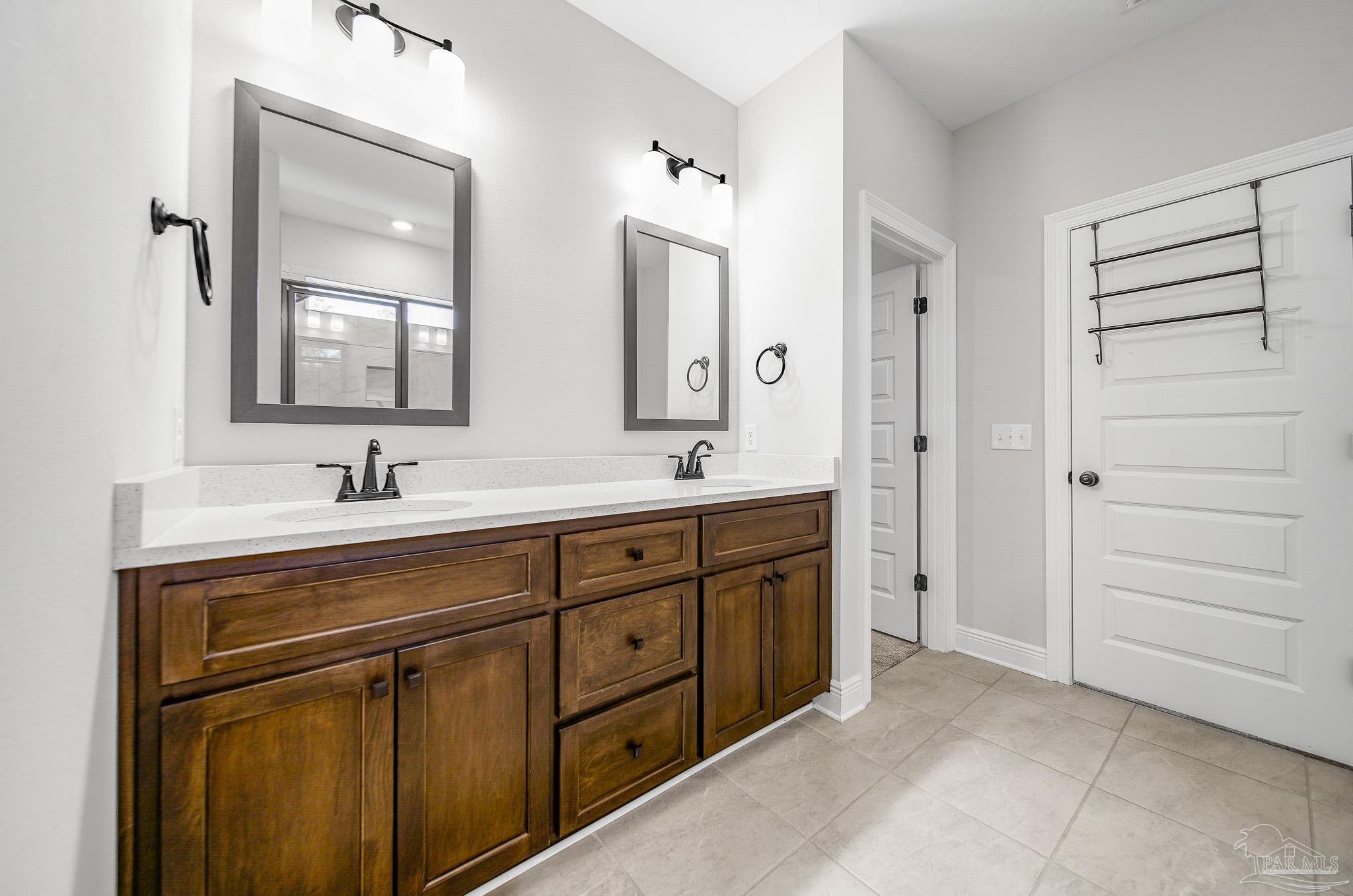 8977 Eureka Street Milton, FL 32583 - Photo 28 of 44 a spacious bathroom with a double vanity sink mirror and double