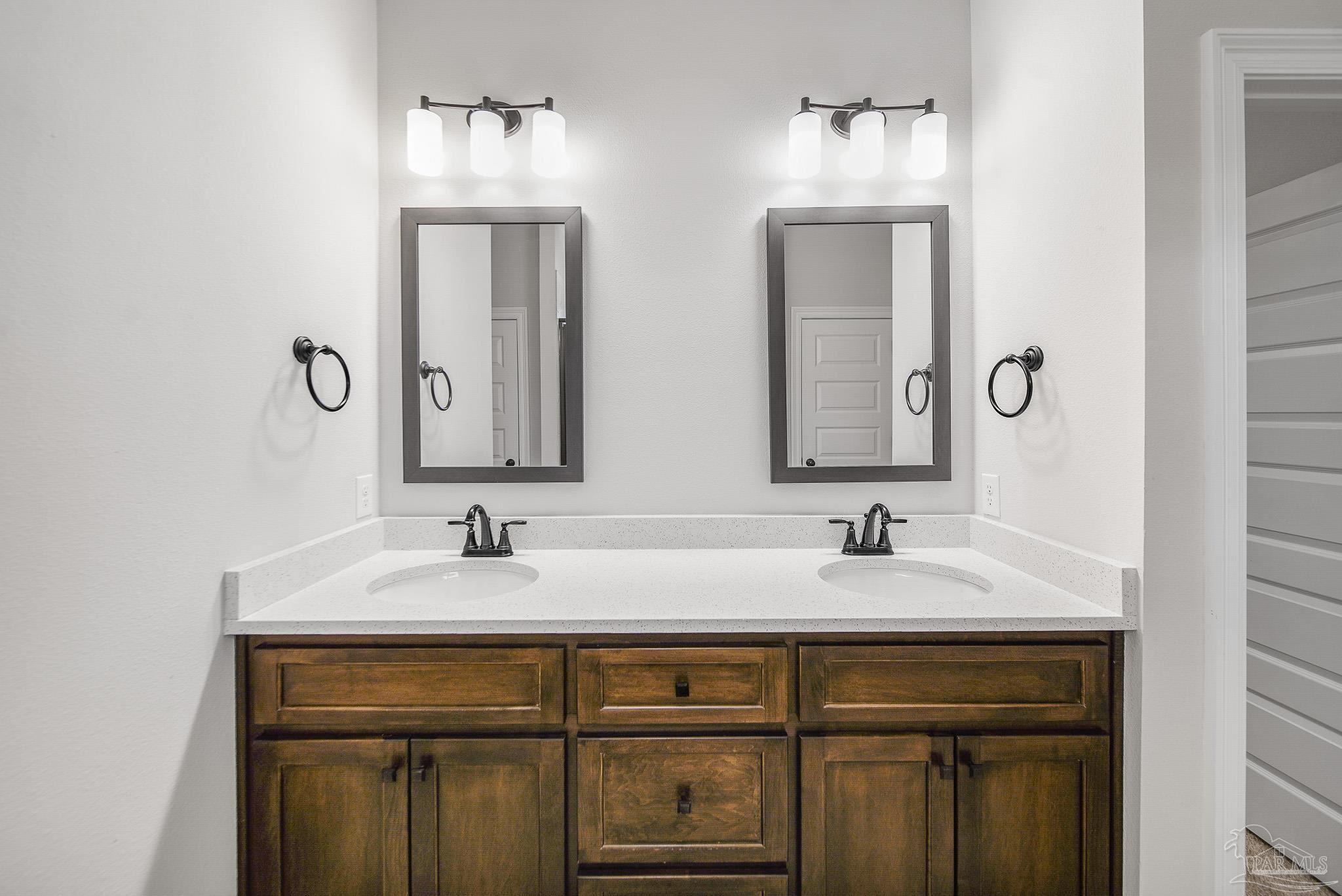 8977 Eureka Street Milton, FL 32583 - Photo 29 of 44 a bathroom with double sink and two mirror