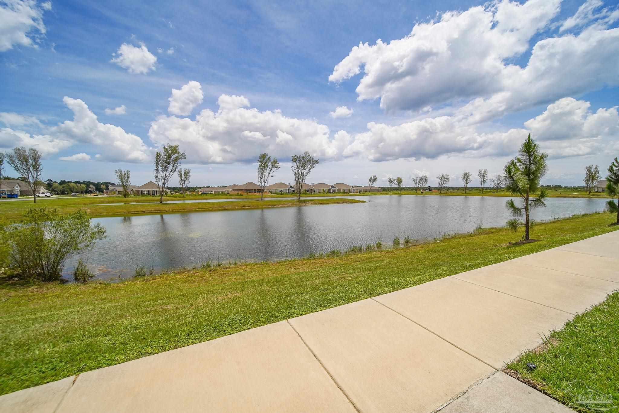 8977 Eureka Street Milton, FL 32583 - Photo 34 of 44 a view of a lake with houses in the back