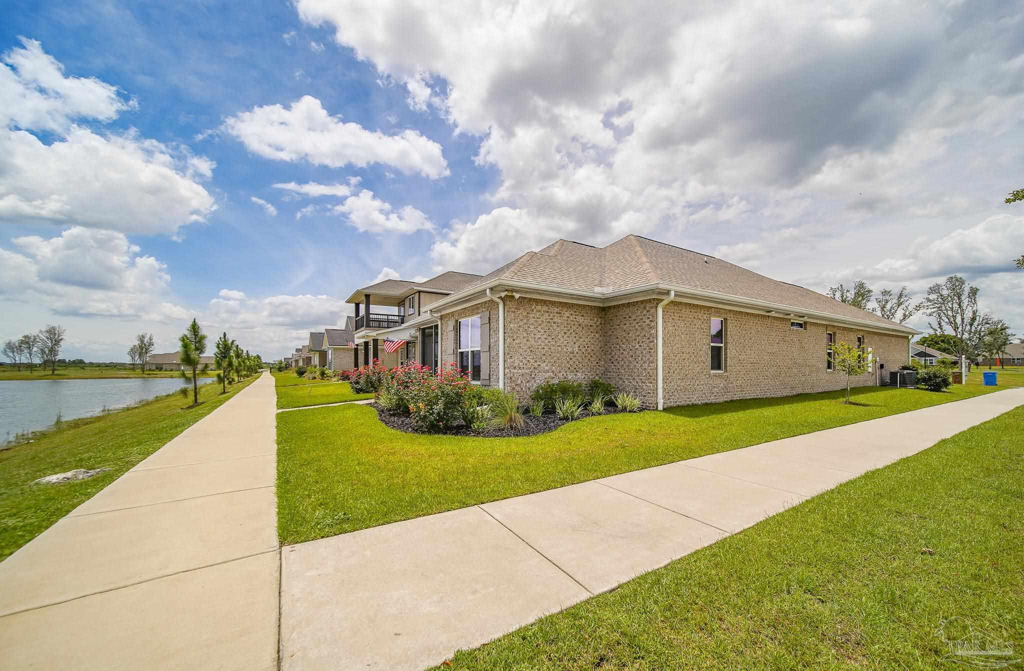 8977 Eureka Street Milton, FL 32583 - Photo 36 of 44 a front view of house with yard and car parked