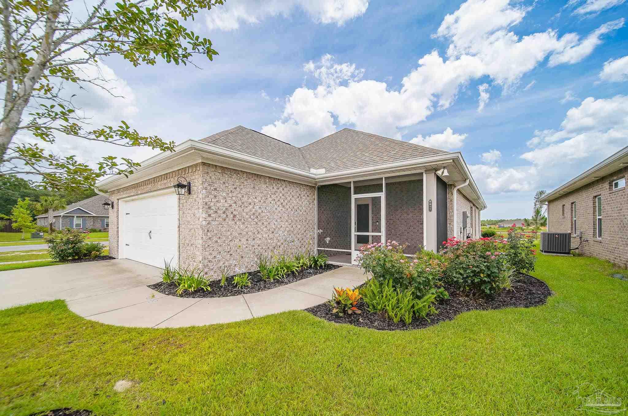8977 Eureka Street Milton, FL 32583 - Photo 38 of 44 a front view of a house with garden
