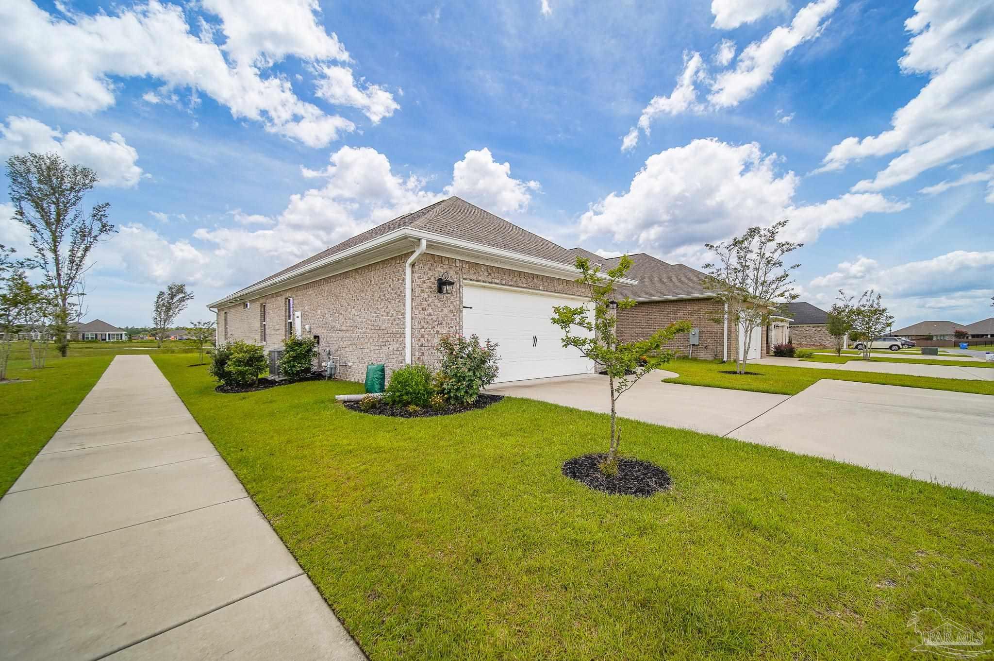 8977 Eureka Street Milton, FL 32583 - Photo 40 of 44 a view of a house with swimming pool and a yard