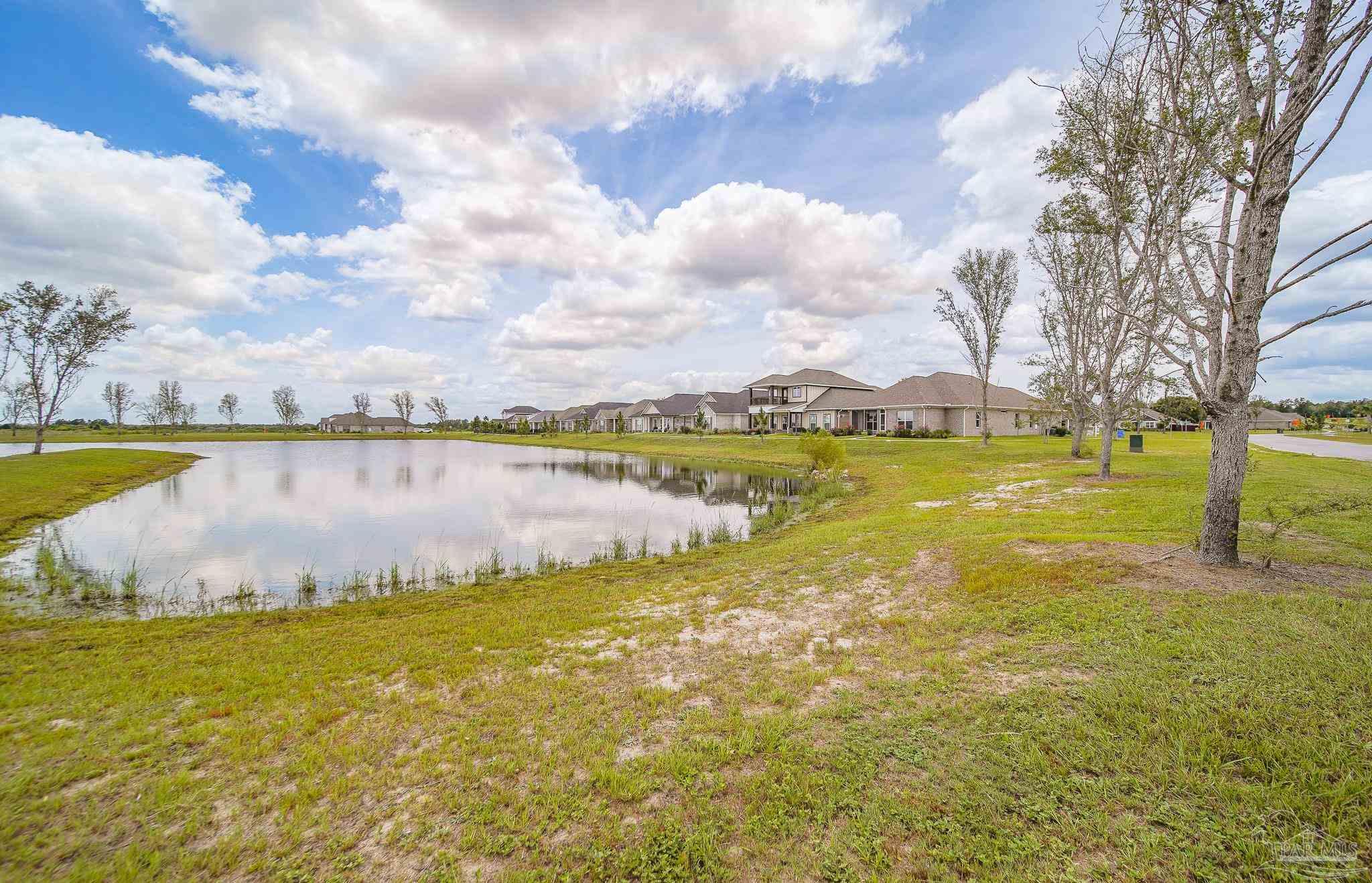 8977 Eureka Street Milton, FL 32583 - Photo 41 of 44 a view of a lake with houses in the back