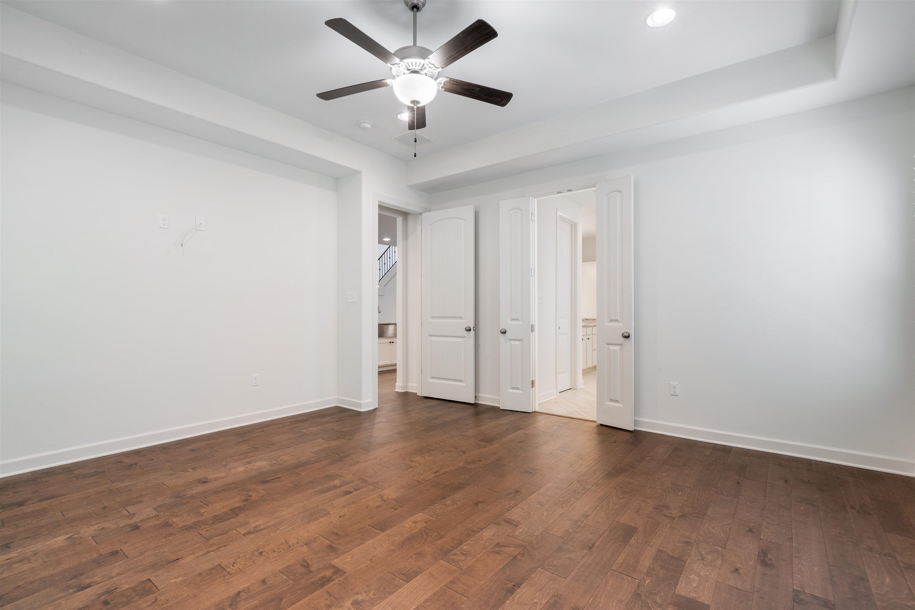 4713 Emmas Circle West Collierville, TN 38017 - Photo 11 of 28 an empty room with wooden floor and a ceiling fan