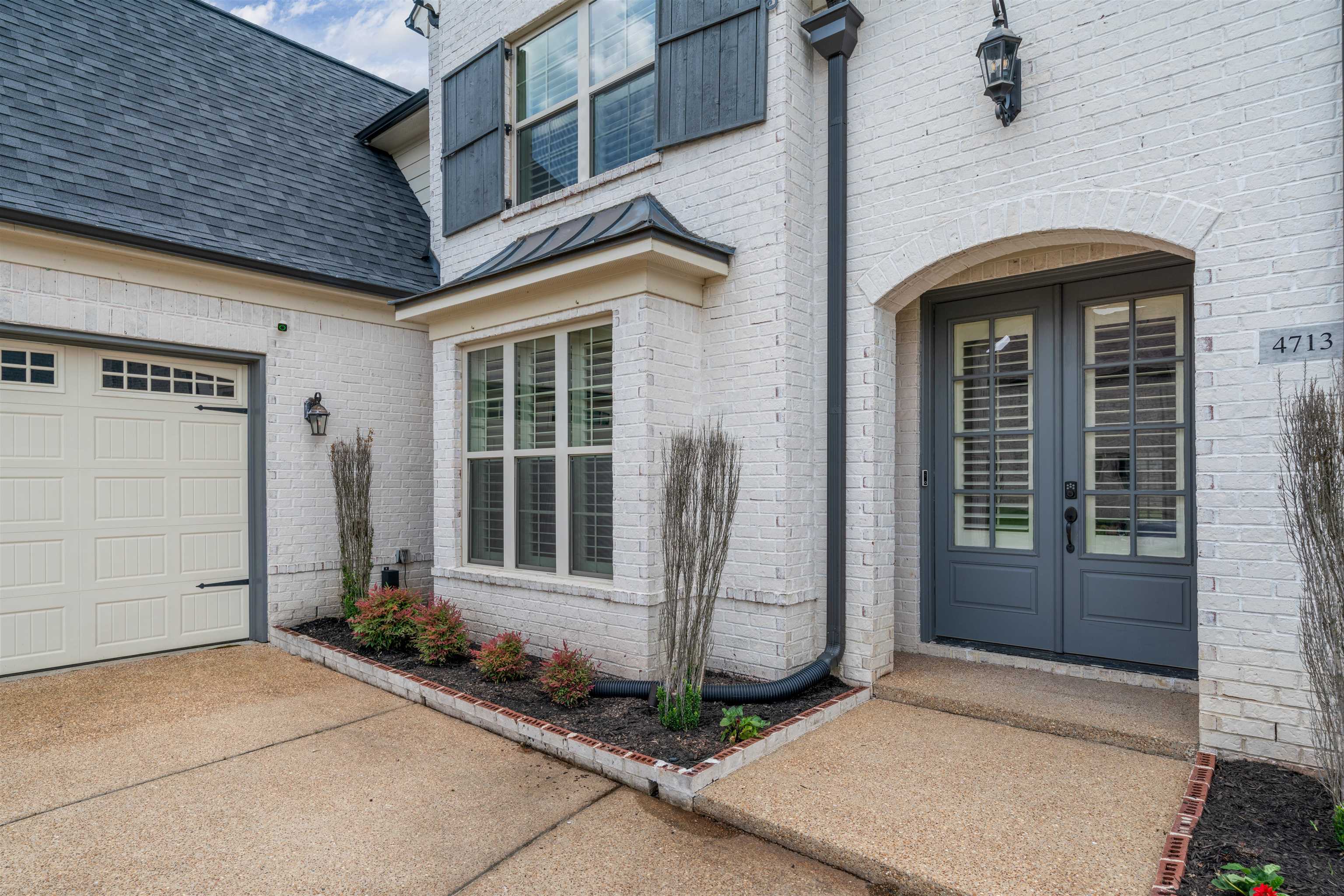4713 Emmas Circle West Collierville, TN 38017 - Photo 2 of 28 a front view of a house with a glass windows and door