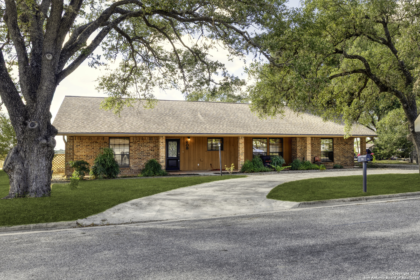208 Mulberry Avenue South Luling, TX 78648 - Photo 1 of 1 a front view of a house with a yard and garage