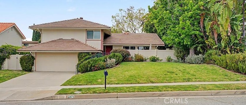 22671 Town Crier Road Calabasas, CA 91302 - Photo 1 of 35 a front view of a house with a yard