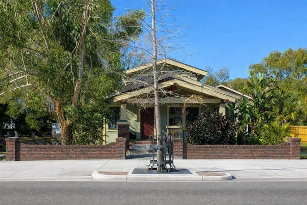 a view of a patio with a table and chairs under an umbrella