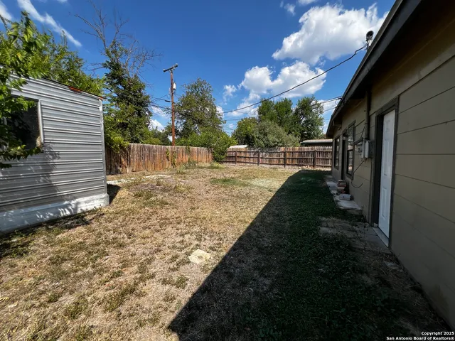 a view of a backyard of the house