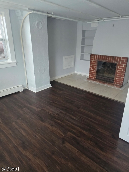 16 Musconetcong River Road, Unit 2 Hampton, NJ 08827 - Photo 11 of 12 a room with wooden floor and a fireplace