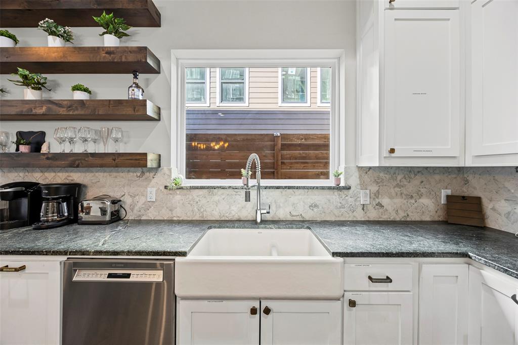 2011 North Prairie Avenue, Unit 2011 Dallas, TX 75204 - Photo 10 of 39 a kitchen with stainless steel appliances granite countertop a sink and a white cabinets