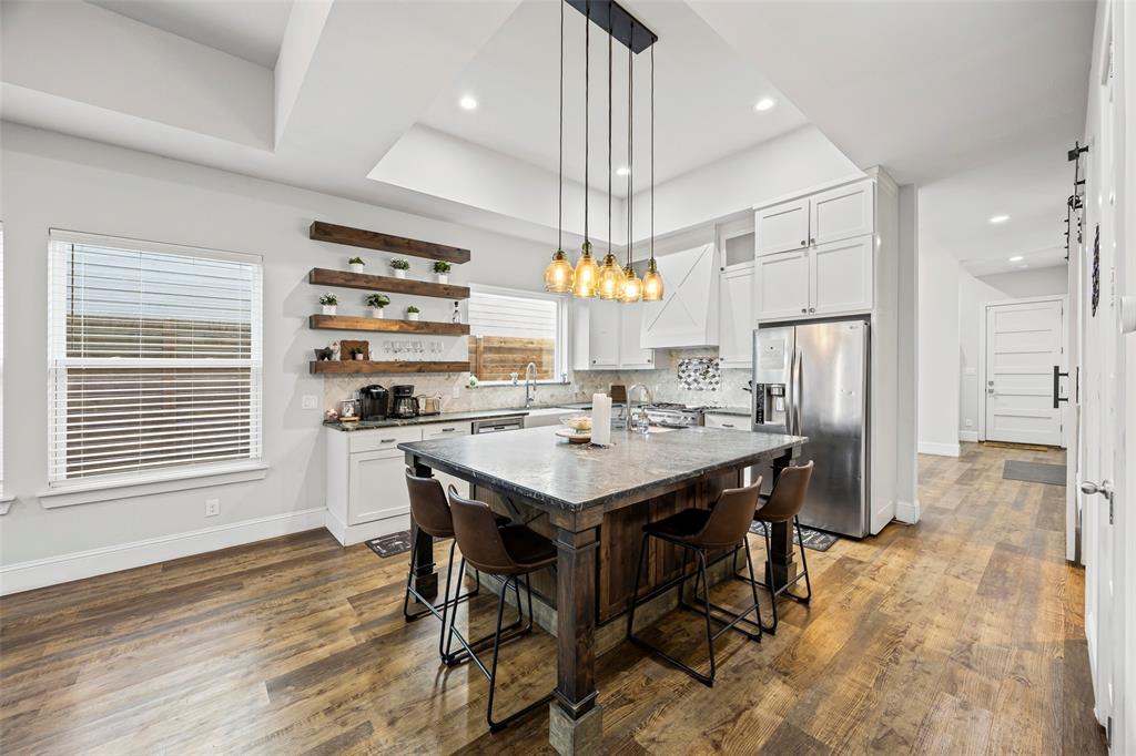 2011 North Prairie Avenue, Unit 2011 Dallas, TX 75204 - Photo 13 of 39 a kitchen with a table chairs refrigerator and window