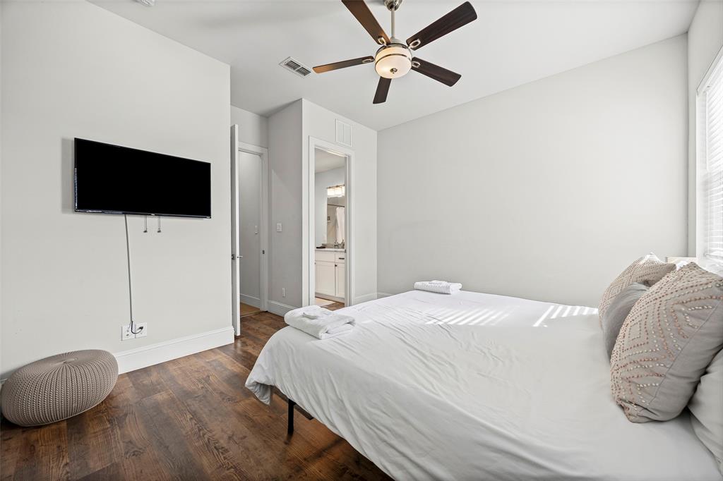 2011 North Prairie Avenue, Unit 2011 Dallas, TX 75204 - Photo 30 of 39 a bedroom with a large bed and a flat screen tv