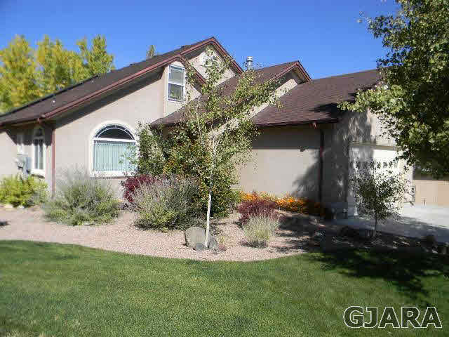 391 Butte Court Grand Junction, CO 81507 - Photo 1 of 11 a front view of a house with a yard
