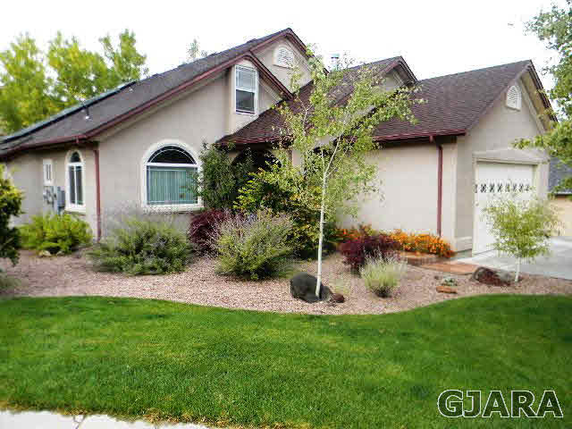 391 Butte Court Grand Junction, CO 81507 - Photo 2 of 11 a view of a house with a yard and plants