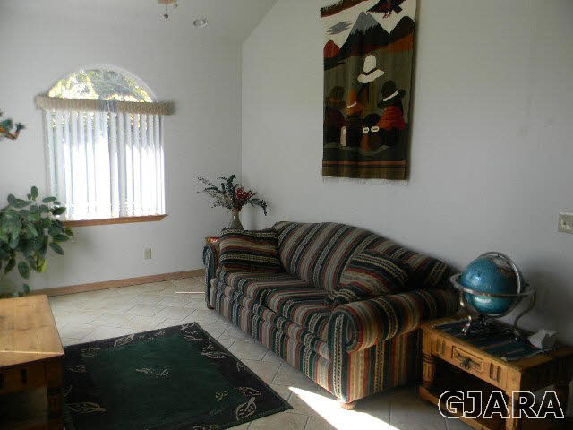 391 Butte Court Grand Junction, CO 81507 - Photo 3 of 11 a living room with furniture and a chandelier