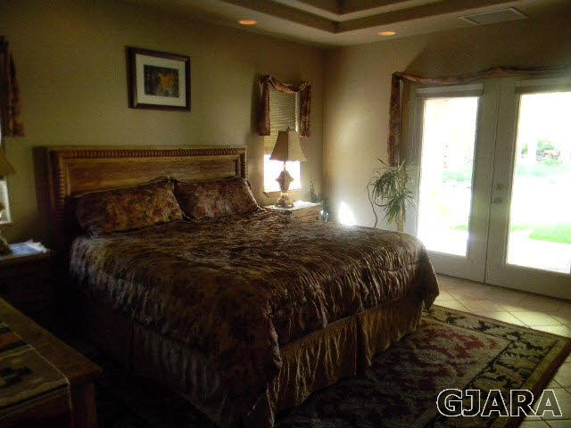 391 Butte Court Grand Junction, CO 81507 - Photo 8 of 11 a bed sitting in a bedroom next to a window