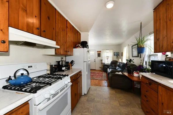 a kitchen with a sink stove top oven and cabinets