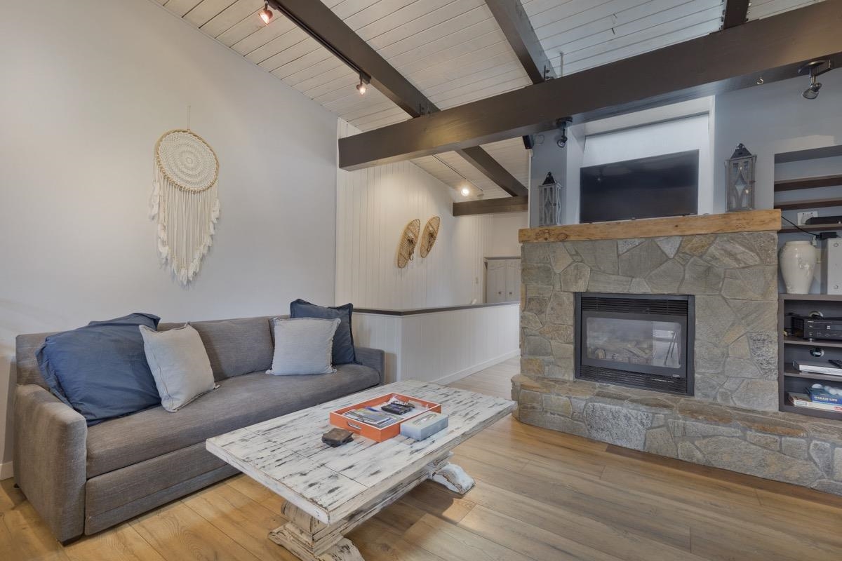 4 Kelley Road, Unit 5 Mammoth Lakes, CA 93546 - Photo 2 of 30 a living room with furniture and a fireplace