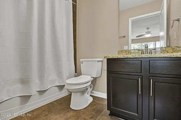 a bathroom with a toilet and a mirror