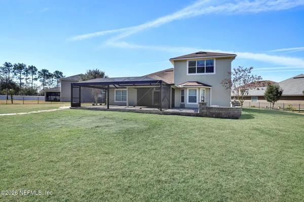 a front view of a house with a garden and yard